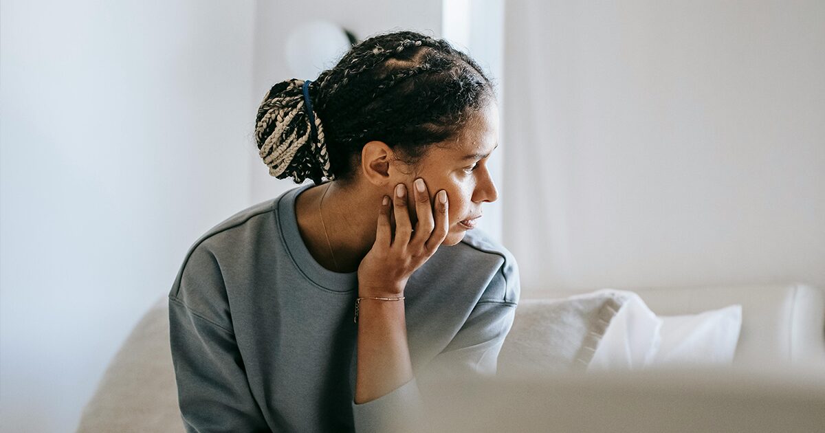 Woman thoughtfully considering how abortion could affect her pre-existing mental health.