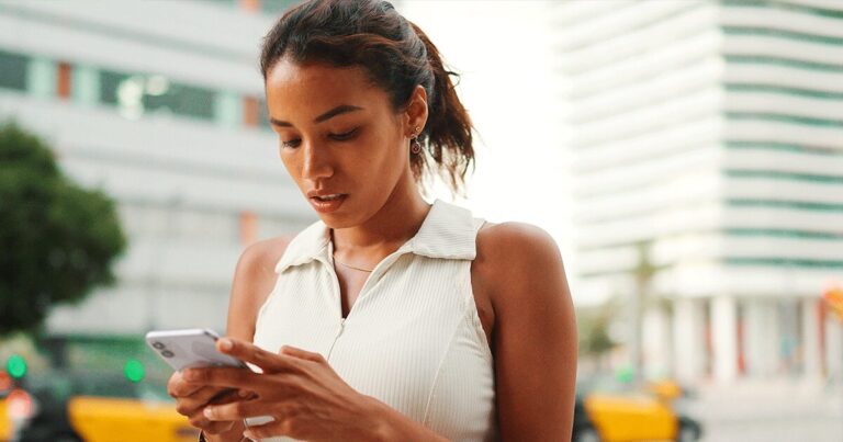 A woman uses her phone to learn why an ultrasound matters before deciding about abortion.